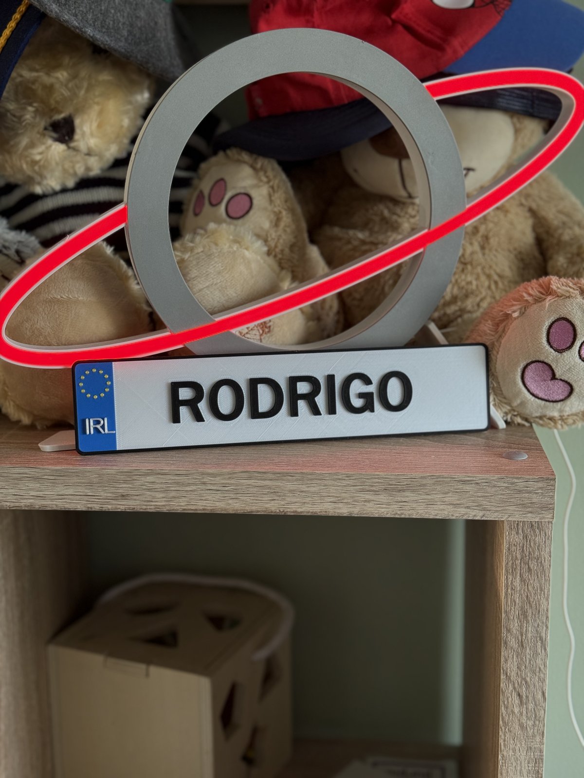 A 3D-printed Irish-style number plate personalised with the name Rodrigo, lit by a red LED ring behind it